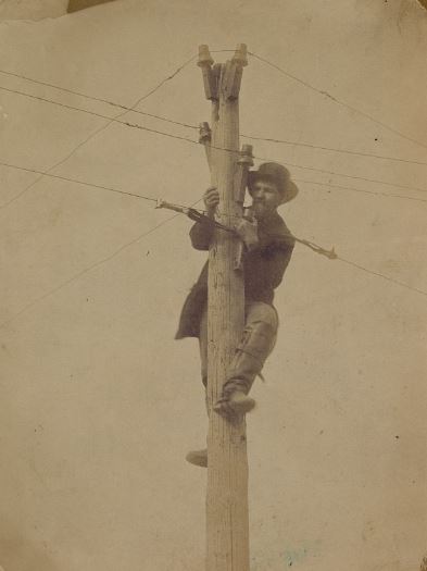 Worker repairing a telegraph in 1862