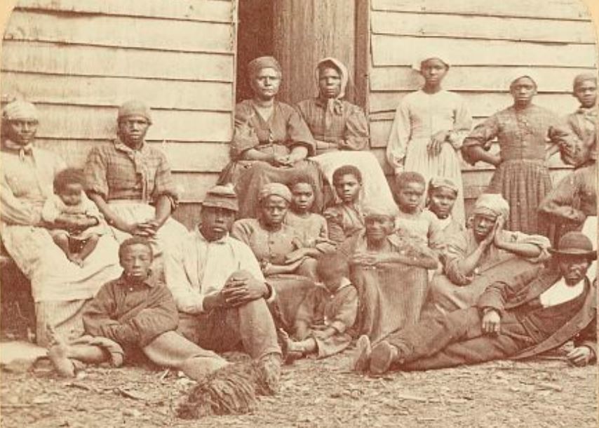 Group of slaves outside a building at the Foller Plantation in Virginia